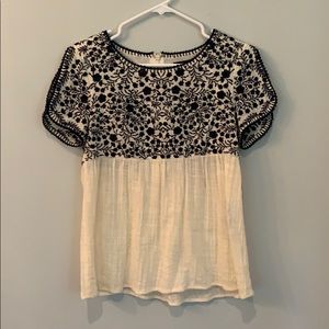 Cream colored blouse with navy blue embroidery